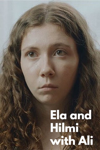 Ela and Hilmi with Ali movie poster